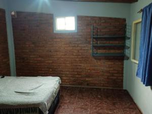 a room with a brick wall and a bed at Los Nonos in Perdriel +6 photos