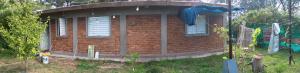 a red brick house with a round window at Los Nonos in Perdriel