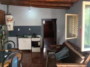 a kitchen with a stove and a couch in a room at Los Nonos in Perdriel