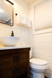 a bathroom with a sink and a toilet and a mirror at NEW! Cozy Container Home at Cliffside #3 in Orderville
