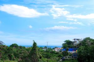 a view of a city with trees and the ocean at Sharays Hideaway in Bull Bay