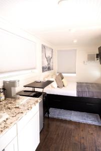 a small bedroom with a bed and a desk at NEW! Cozy Container Home at Cliffside #3 in Orderville