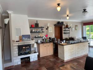 a kitchen with a stove and a fireplace at Gästehaus Windflüchter in Breege