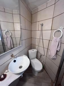 a small bathroom with a toilet and a sink at El estudio de César in Conil de la Frontera +1 photo