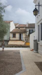 a person walking down a street in front of a house at Y here in Vaison-la-Romaine