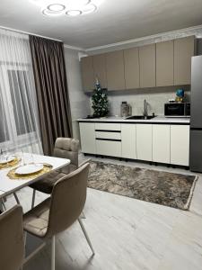 a kitchen and dining room with a table and appliances at Vista Guest House in Yaremche