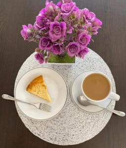 a table with a plate of cake and a cup of coffee at STELLA MARIS Boutique Hotel in El Sargento