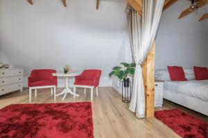 a bedroom with a bed and a table and chairs at The Nest Apartment in Sovata