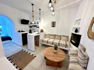 a living room with a couch and a table at Babatseratsi 3 Apartment in Skiros
