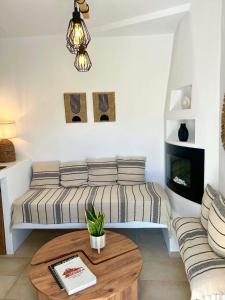 a living room with a couch and a coffee table at Babatseratsi 3 Apartment in Skiros