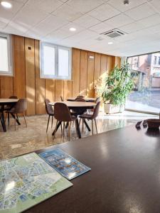 a meeting room with tables and chairs and a map on a table at Hostal Lizana 2 in Huesca