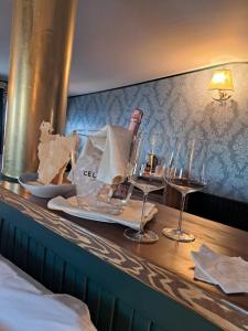 a table with glasses and a bottle of wine on it at Piroscafo Lombardia in Arona