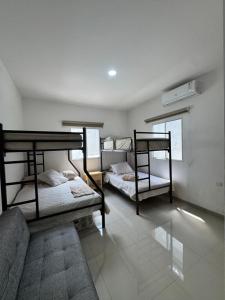 a room with two bunk beds and a couch at Casa Privada con Piscina in Salinas +58 photos