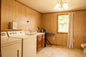 a kitchen with a washer and a sink and a window at Beach Boats Beds in Sneads Ferry +44 photos