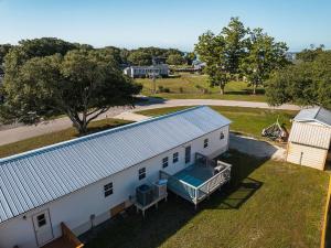 an overhead view of a white barn with a pool at Beach Boats Beds in Sneads Ferry