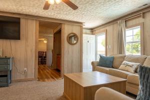 a living room with a couch and a table at Beach Boats Beds in Sneads Ferry