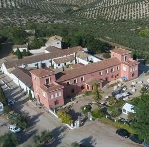 an aerial view of a large pink house with a yard at La Almedina: Palacio de Foronda in Cazorla