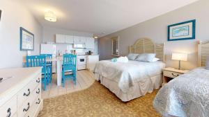 a kitchen and a bedroom with a bed and a kitchen at Oceanfront getaway with Bay-view balcony full kitchen AC in North Truro