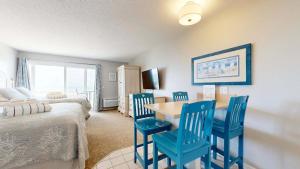 a room with a table and chairs and a bed at Oceanfront getaway with Bay-view balcony full kitchen AC in North Truro +24 photos