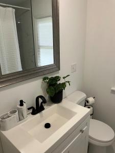 a bathroom with a white sink and a toilet at Philly Content House in Marcus Hook