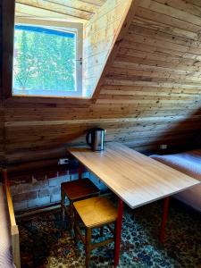 a wooden table in a room with a window at Skruzdėlynas in Nida