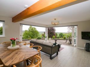 a living room with a table and chairs and a couch at Barn Howe in Kendal