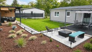 a backyard with a patio with a table and chairs at Ferienhaus Seeoase - 70qm - Kamin -Terrassen - Parkplatz - Badestelle fußläufig in Joachimsthal