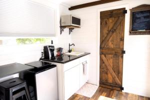 a kitchen with a wooden door and a sink at NEW! Cozy Container Home at Cliffside #4 in Orderville