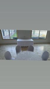 a table and chairs in a room with windows at استراحة لايك لاين ديراب in Ar Riyāḑ