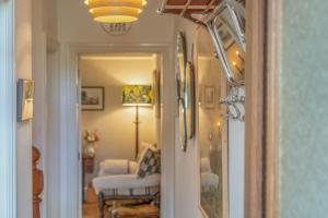 a hallway with a door leading to a room with a chair at North View B&B in Penrith