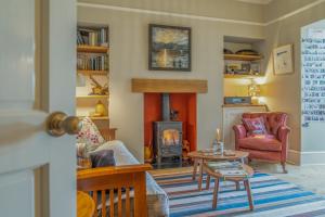 a living room with a fireplace and a fire place at North View B&B in Penrith +34 photos