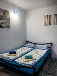 two beds in a room with towels on them at Skadarska in Pančevo +35 photos