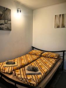 a bedroom with a bed with a comforter on it at Skadarska in Pančevo