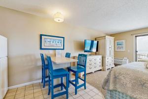 a bedroom with a bed and a table and chairs at Oceanfront hideaway with full kitchen AC sunrise-view balcony in North Truro