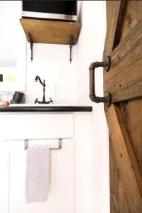 a wooden door in a kitchen with a sink at NEW! Cozy Container Home at Cliffside #4 in Orderville