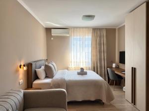 a hotel room with a bed and a couch at Apart Mi in Novi Sad