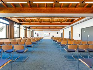an empty lecture hall with chairs in a room at Novotel Grenoble Nord Voreppe in Voreppe +148 photos