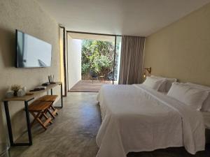 a bedroom with a large bed and a sliding glass door at Statera Host - Pousada de Bem-Estar in Alto Paraíso de Goiás