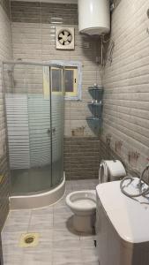 a bathroom with a shower and a toilet and a sink at Zahraa Al-Tal in Baljurashi +12 photos