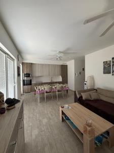 a living room with a couch and a table at Apartman Aloe in Mali Lošinj