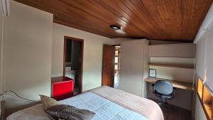 a bedroom with a bed with a wooden ceiling at Refúgio in Ouro Preto +34 photos