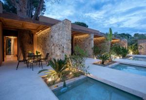 a backyard with a swimming pool and a house at Karidi Beach Gaia Retreat in Vourvourou