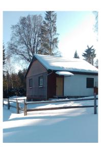 ein kleines Haus mit Schnee darüber in der Unterkunft Kemp Horní Bečva in Horní Bečva