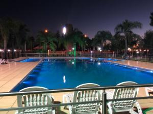 a swimming pool at night with chairs around it at Complejo Foecyt Santa Fe in Colastiné