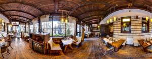a dining room filled with lots of tables and chairs at Momini Dvori Boutique Guest House in Bansko