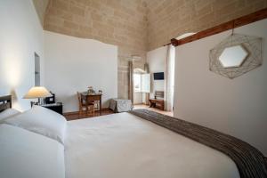 a bedroom with a large white bed in a room at Dimora Santa Barbara in Matera