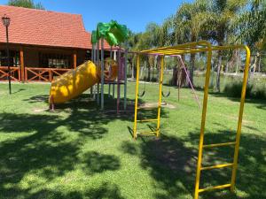 a playground with a slide in a yard at Complejo Foecyt Santa Fe in Colastiné