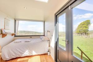 a bedroom with a bed and a large window at 1 Bed in Ponsonby oc-l37879 in Gosforth