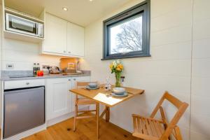 a small kitchen with a table and a window at 1 Bed in Ponsonby oc-l37879 in Gosforth +9 photos