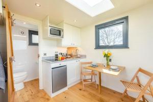 a small kitchen with a table and a sink at 1 Bed in Ponsonby oc-l37879 in Gosforth